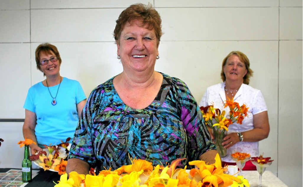 Daylily show organisers Linda Smith (front), Therese Eadie (left) and Adele Saville show off some of the stunning flowers at the weekend. Daylily show organisers Linda Smith (front), Therese Eadie (left) and Adele Saville show off some of the stunning flowers at the weekend.
